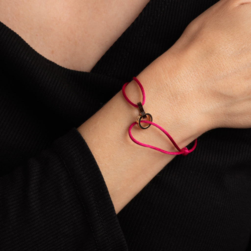 Cartier Love bracelet, Cartier Trinity bracelet on pink cord
