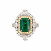 Cocktail ring with emerald and diamonds on a white background
