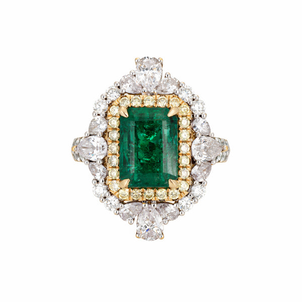 Cocktail ring with emerald and diamonds on a white background