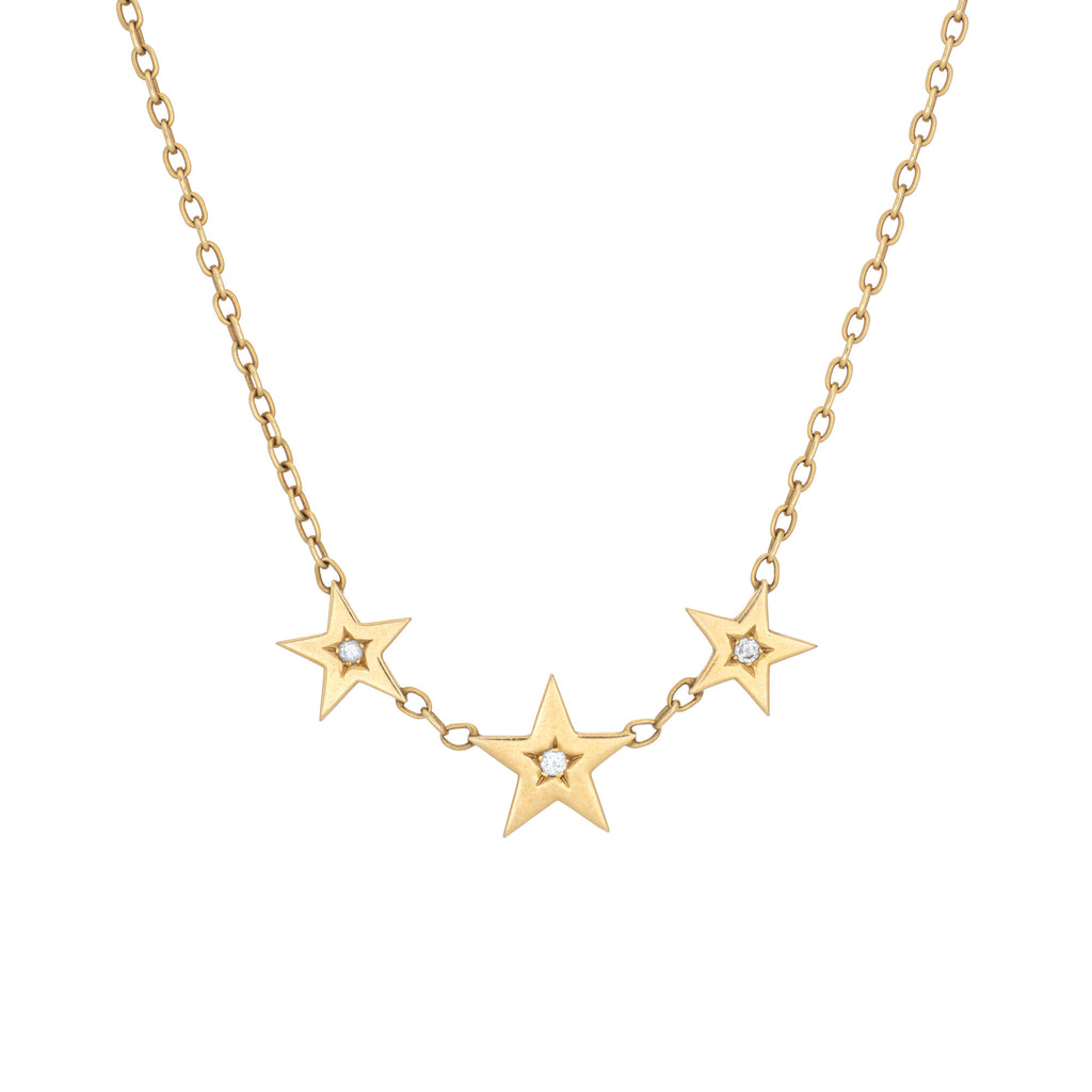 Cartier gold necklace with star-shaped, diamond pendants on a white background