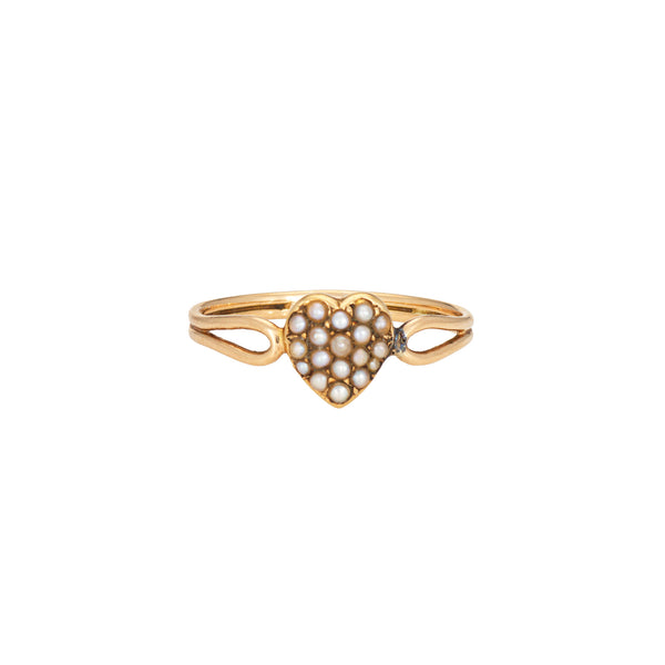 Victorian heart-shaped gold ring with pearl stones on a white background